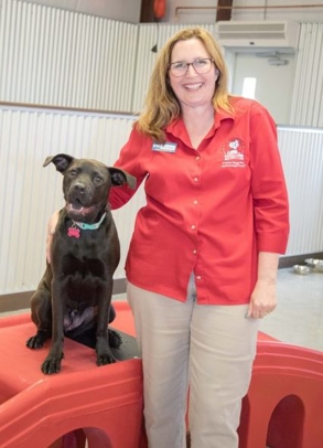 Camp Bow Wow Employee Smiling with Dog