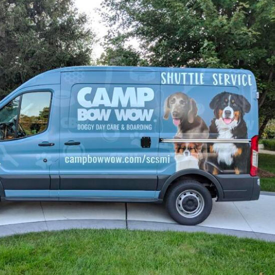 camp bow wow shuttle bus parked on a driveway